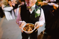 Boy showing pasta bowl from Billotti's Catering pasta bar